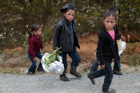 Children accompanying the funeral procession of teenage migrant Gilberto Francisco Ramos Juarez make their way to the cemetery, north of Guatemala City.