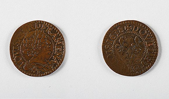 A team of Smithsonian scientists excavating the Hart Chalet site found a double tournois copper coin minted for French King louis XIII in 1634.  In pristine condition, it would have looked similar to this 1638 double tournois coin. (Images courtesy of the National Numismatic Collection, National Museum of American History, Smithsonian Institution. Image composite by Anna Torres)