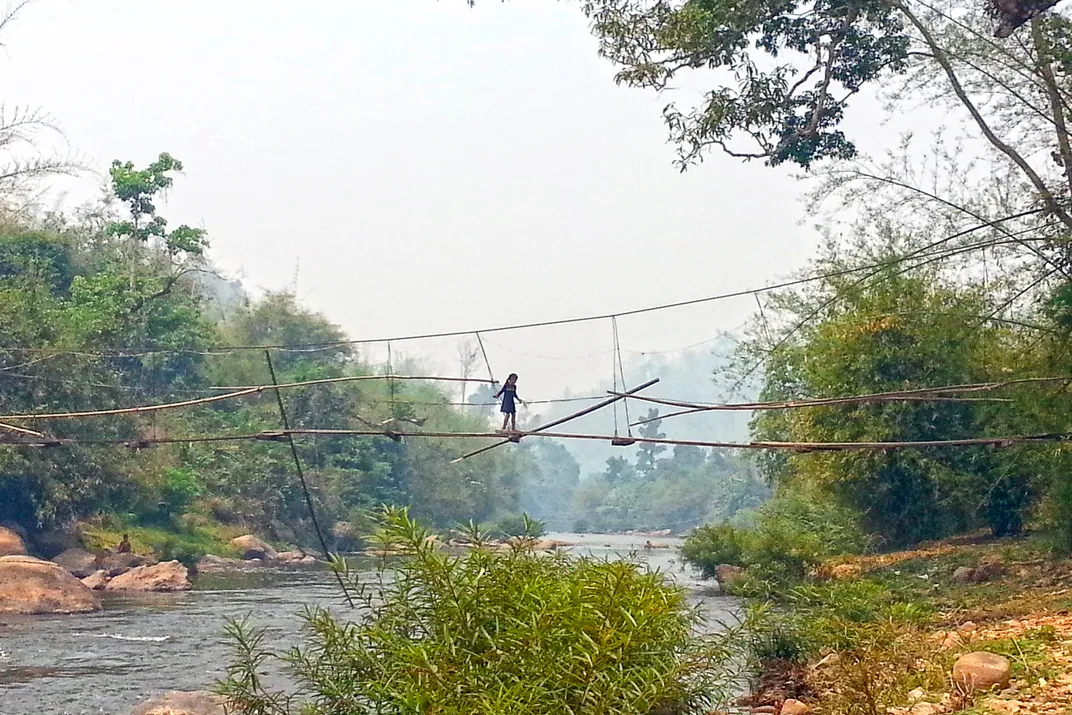 Girl crossing the tiny rope bridge. | Smithsonian Photo Contest ...