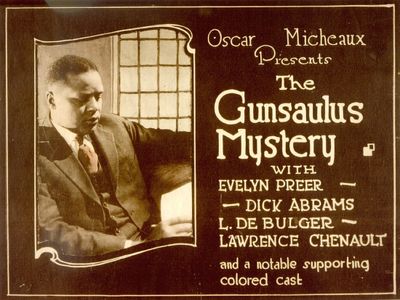 A lobby card for Gunsaulus Mystery, a 1921 silent film written, directed and produced by Oscar Micheaux, an early black silent film auteur. 