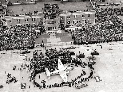 On July 14, 1938, thousands gathered for the return of Howard Hughes, who in four days had flown a Lockheed Super Electra around the world.