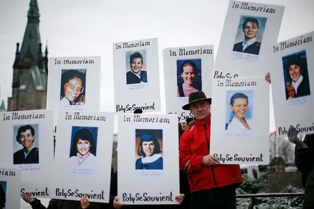 Demonstrators hold portraits of some of the victims of the Montréal Massacre during the National Day of Remembrance and Action on Violence Against Women rally on Parliament Hill in Ottawa December 6, 2011.