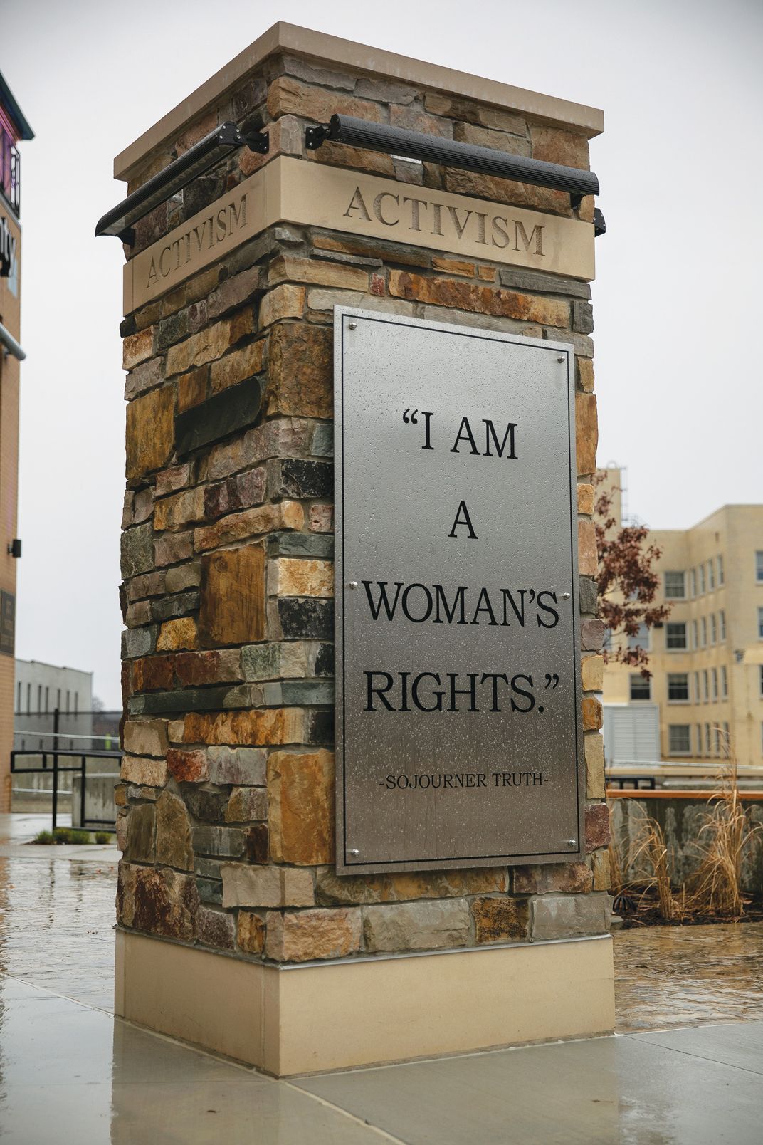a column with the words "I am woman's rights" displayed on it.