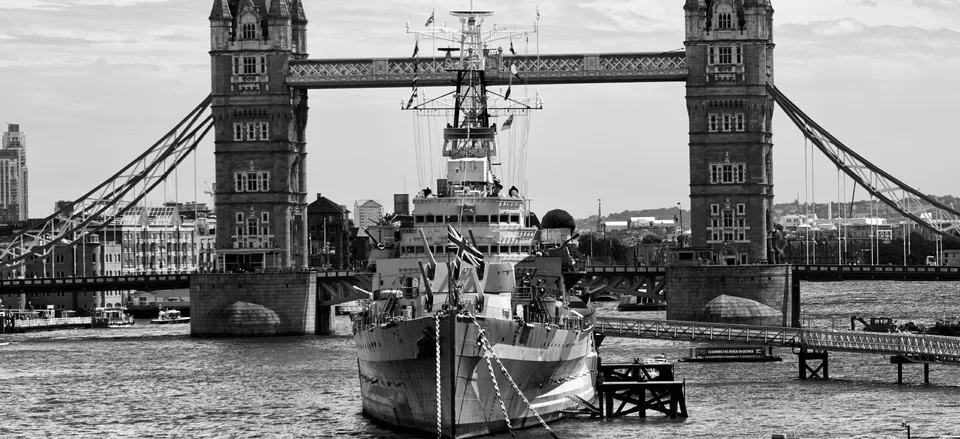  British cruiser HMS <i>Belfast</i> at London's Tower Bridge  