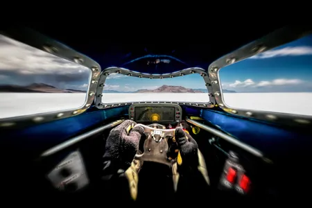 Racer Danny Thompson’s view from inside the cockpit of the Challenger 2 during a run at the Bonneville Salt Flats in August 2016. A HANS (Head and Neck Support) safety device immobilizes his head, so the side windows are only peripherally visible from his vantage point.