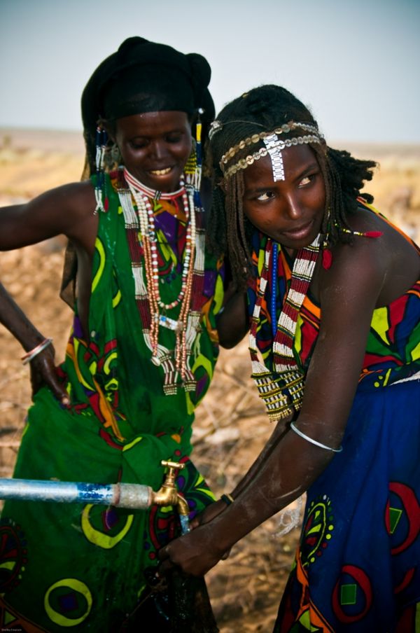 Somali pastoralist women filling animal skins with water in Eastern Ethiopia thumbnail