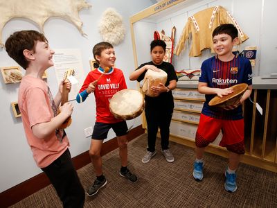 Playing with Native American instruments, fifth-graders from New York City Public School 276 play with percussion instruments made of pelts and other fibers.  