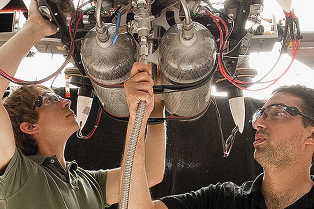 Draper Lab team members Bobby Cohanim (in black shirt) and Eph Lanford check fittings and connections on TALARIS before running a test.