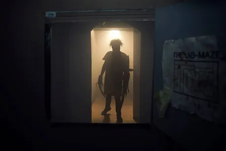 A scary figure emerges in a doorway at Dystopia Haunted House.