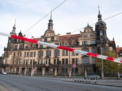 A police barrier tape hangs in front of Dresden's Royal Palace, which houses the Green Vault.