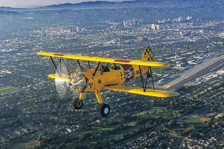 A classic Stearman flying above Santa Monica Airport.
