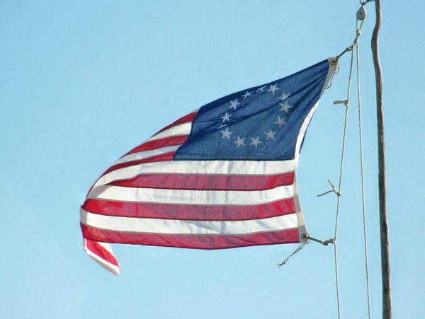 An "old" Old Glory proudly flies in the wind of a living history event in northern Illinois. thumbnail