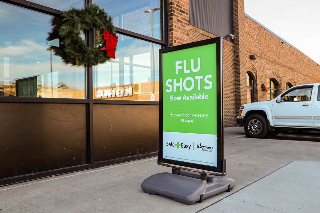 A sign for flu shots outside a Wegmans supermarket
