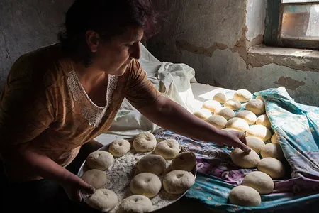 Rima Timbaryan collects dough for baking.