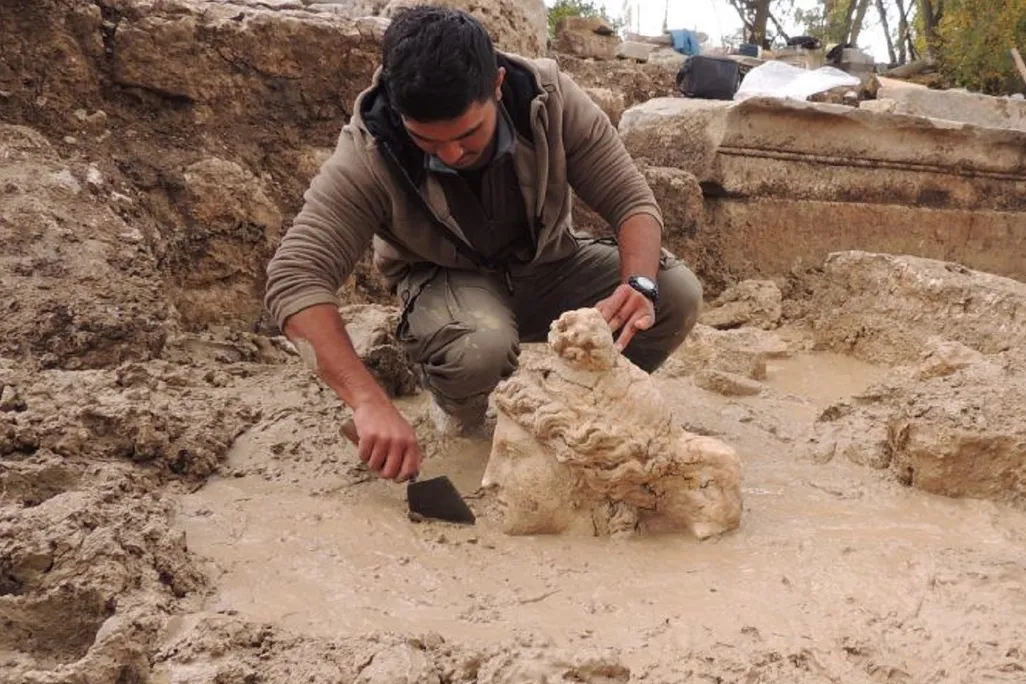 Worker excavating stone head of Aphrodite