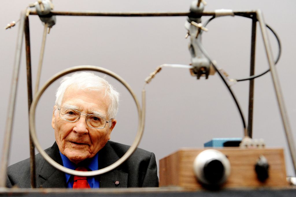 Lovelock looks through one of two wire circles on a small machine