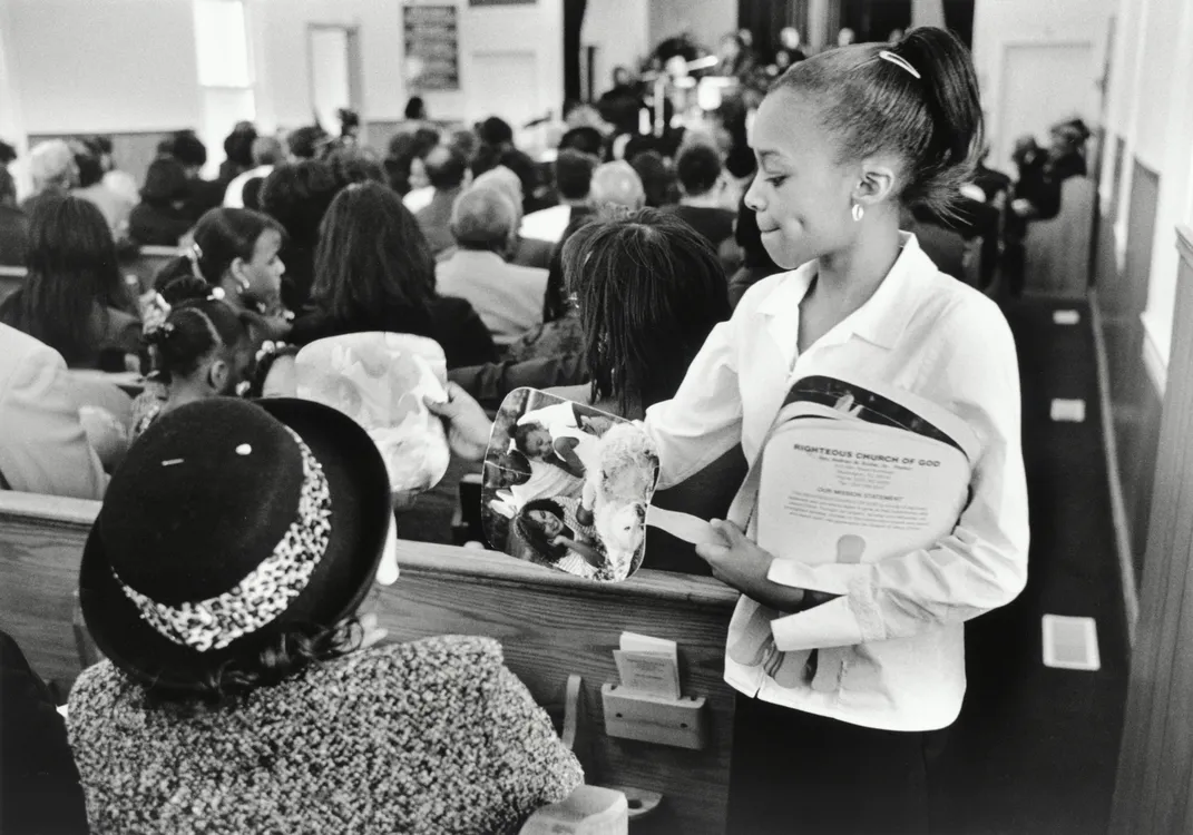 Youth Usher Vivica Brooks Passes Out Fans, Jason Miccolo Johnson, 2012