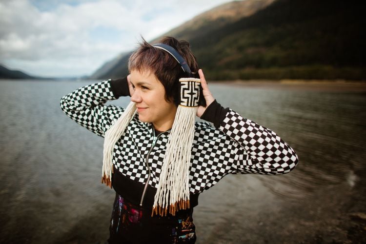 a model wears woven headphones with long tassels