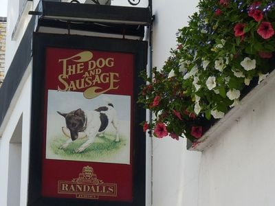Pub signs illustrat the creative names of local watering holes, like the Dog & Sausage in St. Helier, Jersey. 