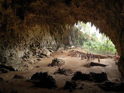 Liang Bua cave on Flores Island, where Homo floresiensis remains were discovered in 2003. Nearby is a village where the pygmies live. 