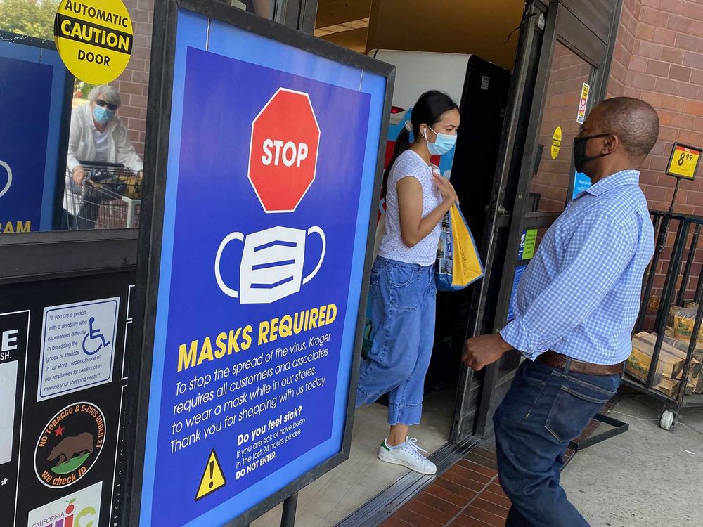 Individuals Wearing Masks Into Grocery Store