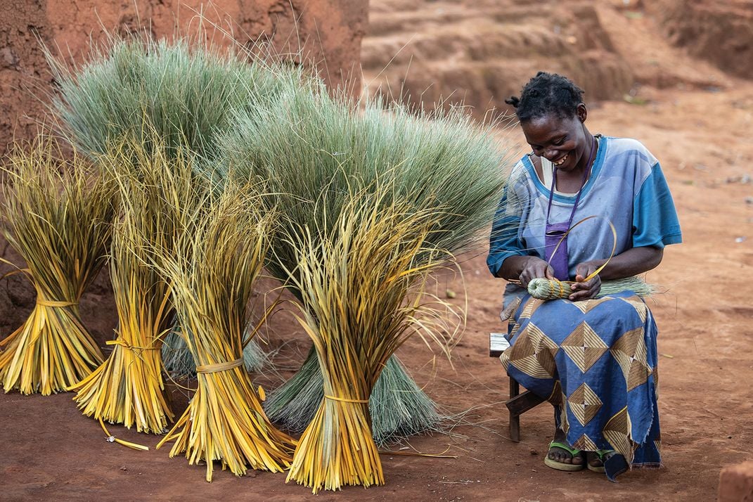 Ovilela Banda, of Muonkera Village, makes traditional brooms using a tall grass that grows at higher elevations, usually requiring a hike of several hours to harvest.