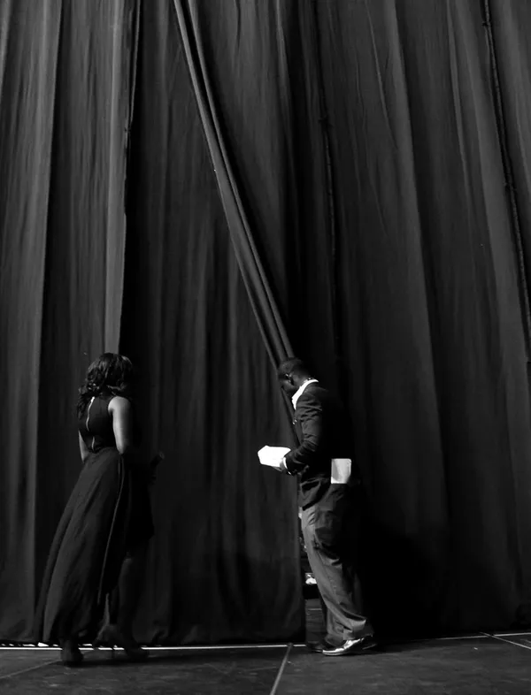 A young man holds the curtain for a young woman during the Florida Invitational Step Show, which is the largest student run step show in the Southeast. It is organized annually by the Black Student Un thumbnail