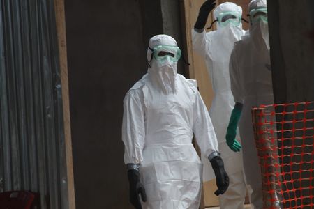 Nurses in a Liberian hospital dressed in protective clothing to prevent the spread of Ebola
