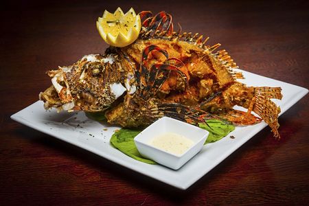 One of Chef Bun Lai's recipes: A dish that features whole fried invasive lionfish at Fish Fish of Miami, Florida.