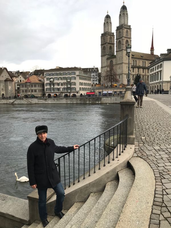 A Russian man posing in front of Grossmunster in Zurich thumbnail