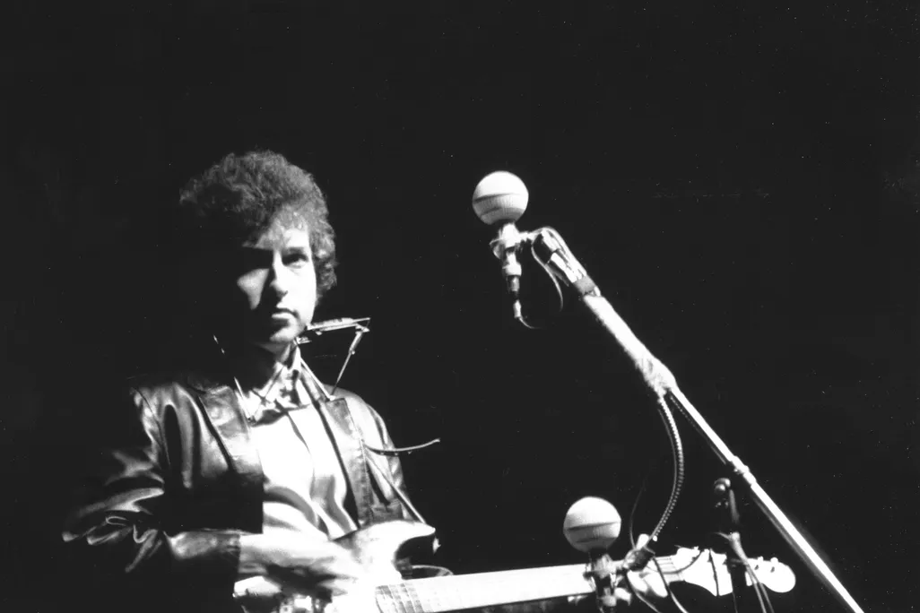 Bob Dylan plays a Fender Stratocaster electric guitar at the Newport Folk Festival