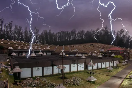 Illustration of the GRAPES-3 Muon telescope in a lightning storm.