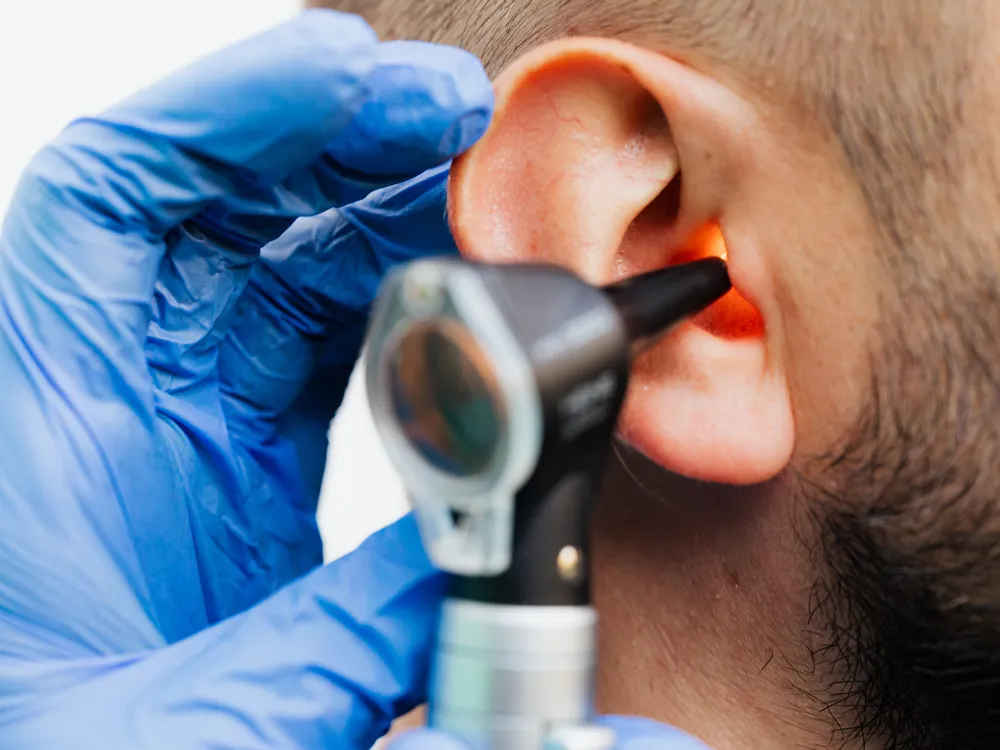 Doctor looking into someone's ear