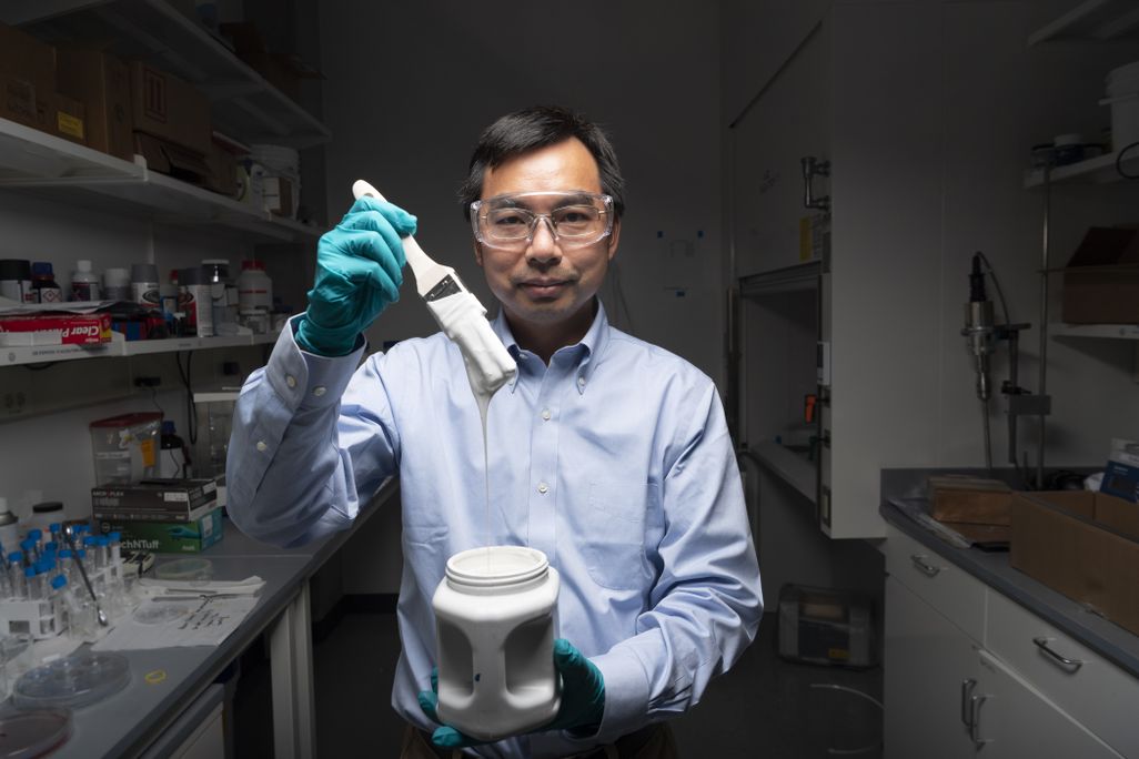 Xiulin Ruan holding paintbrush
