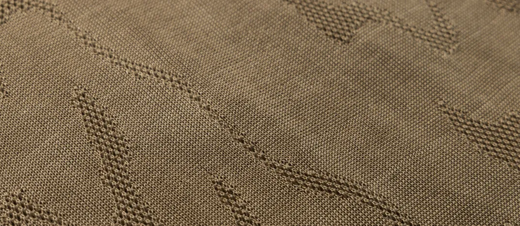 A close-up shot of knit fabric with a pattern