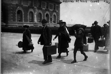 Immigrants arriving at Ellis Island with their possessions in 1907.