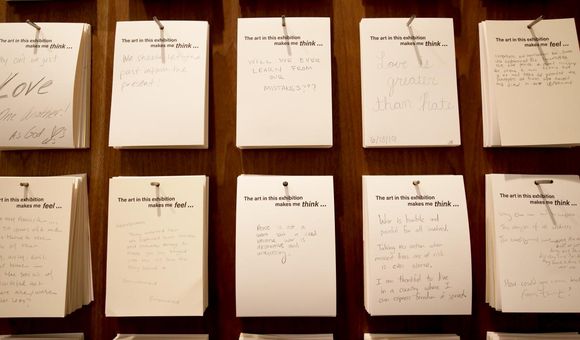 Visitors leave hand-written notes after viewing the exhibition, 