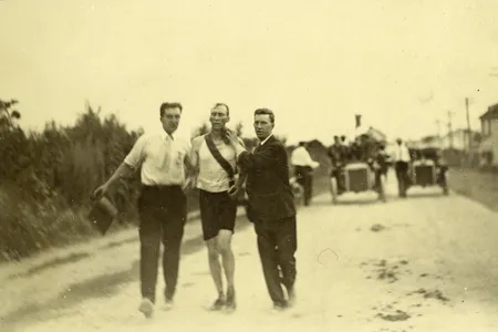 Attendants assist Thomas Hicks, an American runner who consumed strychnine, egg whites and brandy during the race.