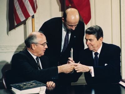 U.S. President Ronald Reagan and Soviet leader Mikhail Gorbachev exchange pens during the signing ceremony for the Intermediate Range Nuclear Forces Treaty in the White House East Room on December 8, 1987. 
