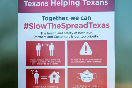 A Covid-19 restrictions sign hangs outside a supermarket in Austin, Texas. Lauren Ancel Meyers at the University of Texas at Austin has shared her team’s modeling results with city officials who make decisions about Covid-19 measures.
