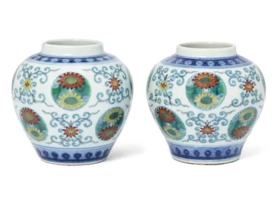 An associated pair of Chinese doucai &quot;lotus and chrysanthemum&quot; jars from the Qing Dynasty