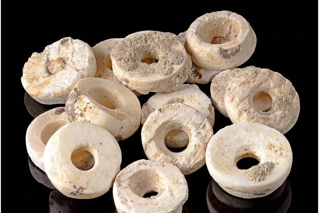 Disc-shaped white beads against a black background
