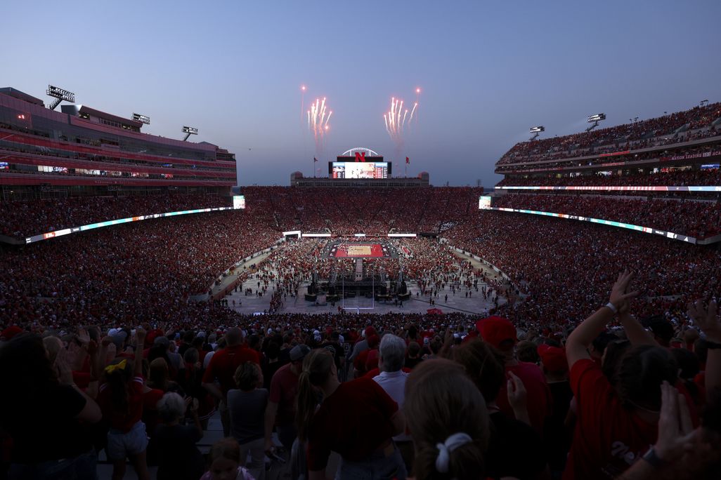 Dusk at a football stadium with fireworks in background