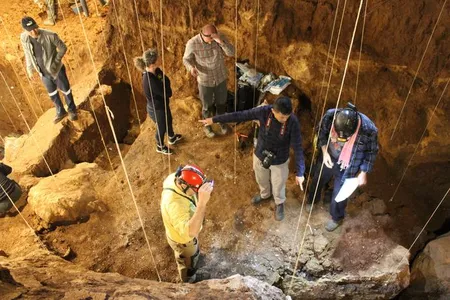 Researchers take sediment samples in the excacation pit in the&nbsp;Tam P&agrave; Ling cave in Laos, where two newly uncovered human bones&mdash;part of a skull and a shin bone&mdash;were found.