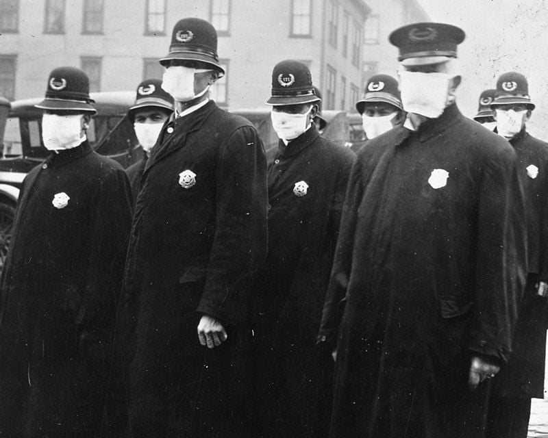 Police officers wear masks