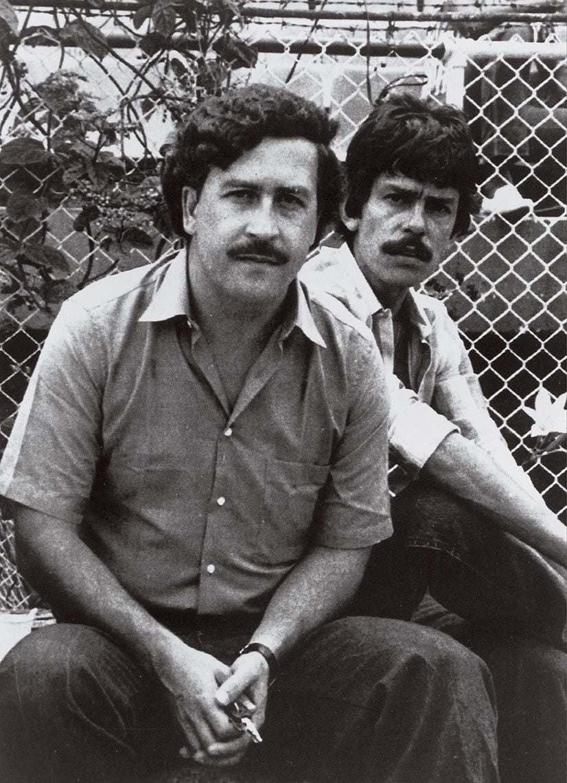 Escobar, left, and a bodyguard, at a soccer game in Medellín in 1983