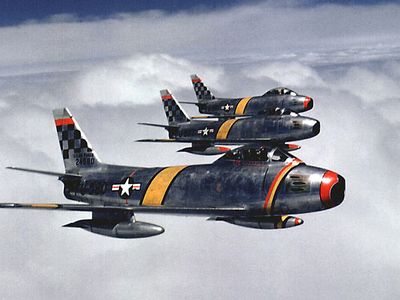 Three F-86s flying in formation over Korea.