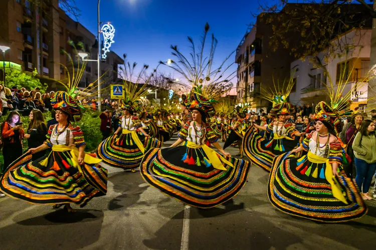 dancers in colorful outfits in a parade