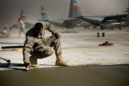 Airman 1st Class Joshua Toth, 455th Expeditionary Civil Engineer Squadron heavy equipment operator, smooths wet concrete on Thanksgiving, Nov. 27, at Bagram Air Field, Afghanistan. Airman toth is from Clayton, N.J. and is thankful for being in Afghanistan, serving his country. (U.S. Air Force photo by Staff Sgt. Samuel Morse)(Released)