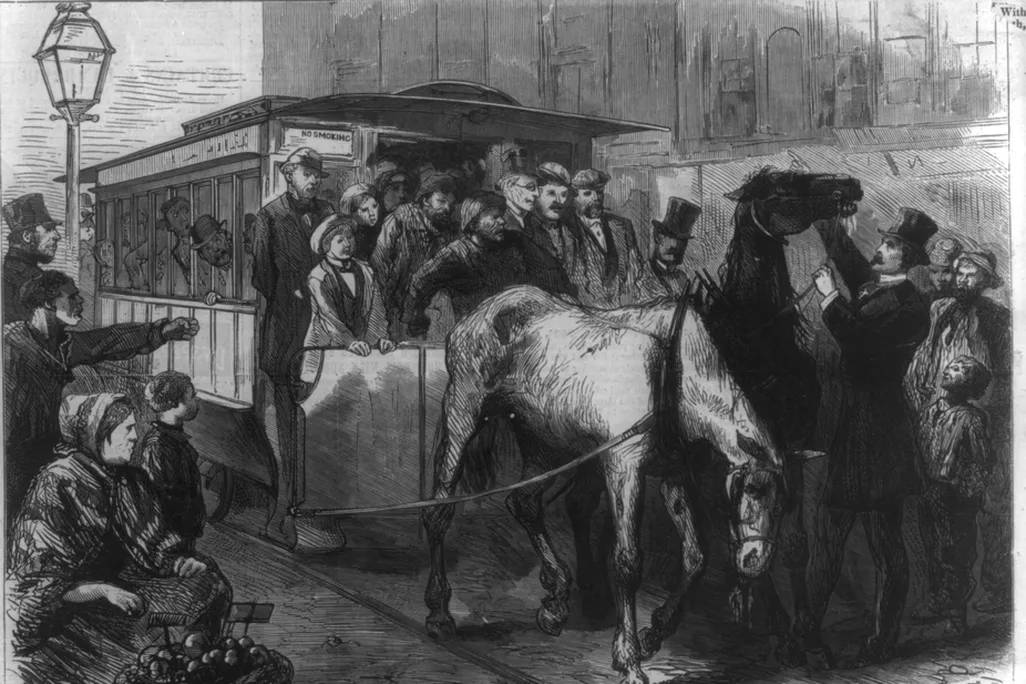 Man in top hat touching horse pulling a streetcar, as a tired horse droops its head